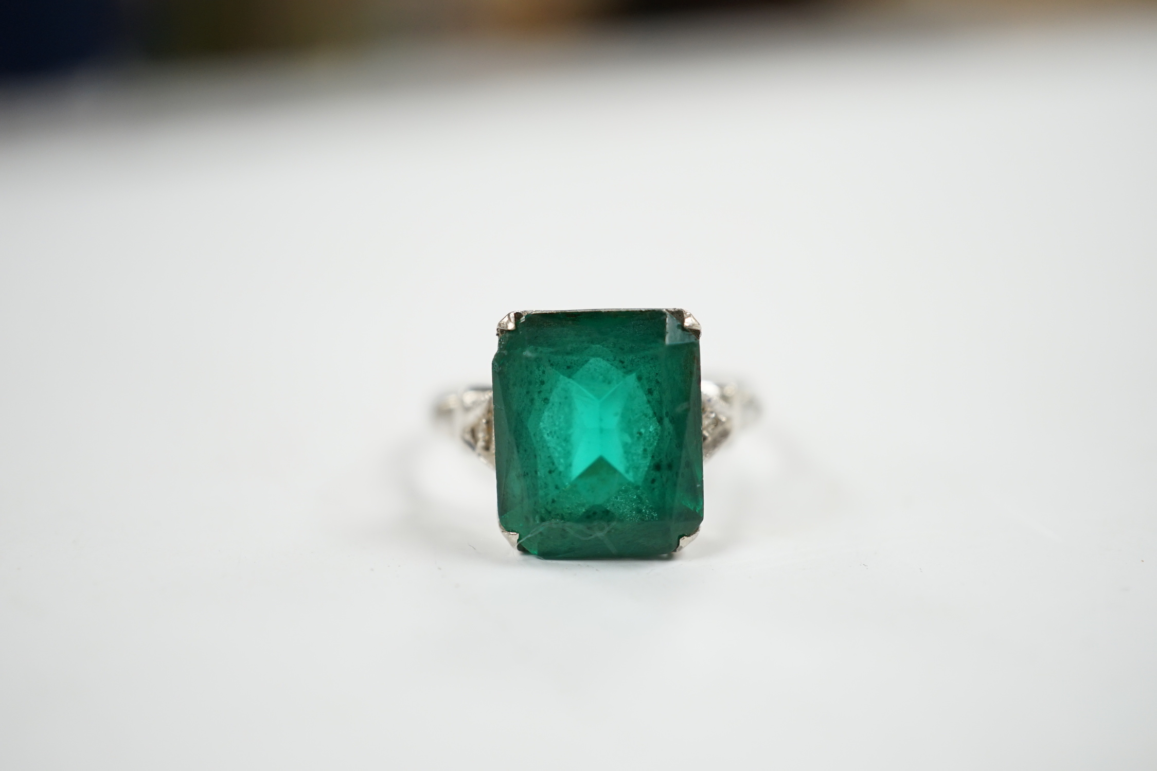 A 14k and single stone green paste set ring, with diamond chip set shoulders, size P, gross weight 3.5 grams.